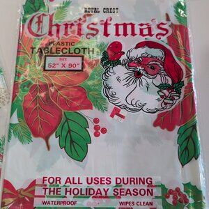 2 Packages Of Vintage ROYAL CREST Christmas Plastic Table Cloths Santa Poinsetta